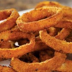 some onion rings are on a white plate