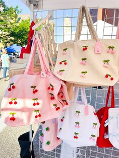 The cutest cherry tote bag with red and pink dangling cherries! Perfect to take with you to the farmers market or grocery shopping. Please note that the cherries are only on one side of the bag. Choose from two tote styles: ♥Rope Tote (beige) - measures 20"W x 15"H x 5"D and is made of heavy cotton canvas. This bag is boxy on the bottom, so you can lay your items flat inside.Features rope handles and has an inside pocket with zipper. The bag closes with a magnetic snap. ♥White/Pink Tote - Measures 20"W x 15"H x 5"D and is made of 100% heavy cotton canvas. This bag is boxy on the bottom, so you can lay your items flat inside. ♥ Check out all my tote bags here https://www.etsy.com/shop/LeeMorganDesigns?ref=seller-platform-mcnav&section_id=38820830 ♥ VISIT THE MAIN SHOP PAGE ♥ https://www.ets Cheap Pink Strawberry Print Bags, A Cute Bag White And Pink, Trendy Strawberry Print Bag At Affordable Price, Cheap Strawberry Print Summer Bags, Playful Red Summer Bags, Cute Red Bags For Spring, Fun Spring Tote Bag, Spring Fun Tote Bag, Rectangular Summer Grocery Shopping Bags