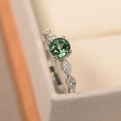 This ring features a (6*6 mm oval cut green sapphire). Customization is available. It is made by hand, and it will take about 7 days to finish the ring after your payment is completed. Main stone: 6*6mm oval cut Main stone weight:1.02ct Metal type: sterling silver finished with rhodium/14k gold Accent stone: cz Customization is available, I also can make it with 14k solid gold (white or yellow or rose) and diamond accent stone, just feel free to contact me. Any question, just let me know. :) My Green Crystal Wedding Ring Silver, Green Stone Promise Ring, Emerald Stone Engagement Ring Silver, Silver Rings With Green Stones, Green Stone Silver Ring, Sapphire Green Engagement Ring, Silver Ring With Green Stone, Silver Ring Green Stone, Green And Silver Ring