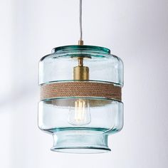 a glass and rope light hanging from a ceiling