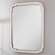 a mirror mounted to the side of a wall