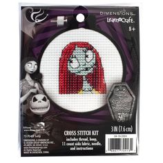 the cross stitch kit features a red haired girl with long hair and an evil face