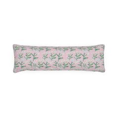 a pink and green rectangular pillow with white flowers on the front, sitting on a white background