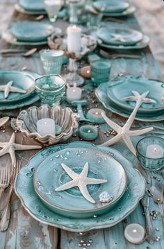 the table is set with starfish and seashells for an ocean themed dinner