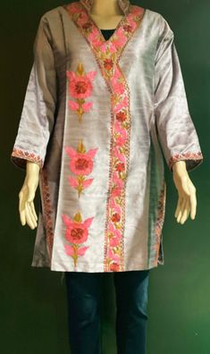 Embroidered Tunic Crafted from raw Silk, designed in Classic Kashmiri Aari embroidery.  Match it with a pair of denims or leggings perfect for Women and Girls a classic tunic that never goes out of fashion. ThisTunic features intricate  embroidery on the neckline, sleeves, the side hem and motif on the front. A combination of vibrant shades with a beautiful play of colors. Color: silk Pink -Color can vary due to lighting. All sizes  are approx.  Size: USA, M  Chest:38 inch.  Shoulder: 17 inch.  Sleeve length: 18 inch  Length: 33 inch. Fabric: Raw Silk- Dry clean or hand wash, iron on low heat. Made in a smoke and pet free home. Made in Kashmir, India Traditional Chanderi Kurta With Embroidered Neckline, Navratri Floral Embroidered Raw Silk Kurta, Bollywood Style Kurta With Embroidered Neckline For Eid, Designer Spring Kurta With Embroidered Border, Chanderi Resham Embroidery Straight Kurta Top, Spring Designer Wear Kurta With Embroidered Border, Straight Kurta Top With Resham Embroidery In Chanderi, Bollywood Style Festival Kurta With Embroidered Neckline, Bollywood Style Embroidered Kurta For Festivals