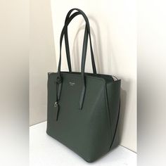 Kate Spade Margaux Medium Tote Dark Green Refined Grain Leather Color Code: Pine Grove (300) New With Tags; Authenticity Guaranteed! Pxrua229 / Retail $278 Kate Spade Gift Bag Included Our Margaux Large Tote Is Defined By Its Curved, Feminine Silhouette, Molded Handles, Functional, And Roomy, Interior. Crafted From Refined Grain Leather, It Features A Creamy Lining That Reminds Us Of Cake (And You Know How We Feel About That) And A Pocket Inside. The Luggage Tag On The Handle Has An Upside Down Kate Spade Saffiano Leather Bags For Daily Use, Elegant Saffiano Leather Bags With Interior Card Slots, Green Textured Leather Bags For Work, Kate Spade Saffiano Leather Bags For Work, Kate Spade Saffiano Leather Bags, Luxury Green Shoulder Bag For Work, Luxury Green Workwear Shoulder Bag, Classic Green Bags For Work, Modern Kate Spade Bags For Office