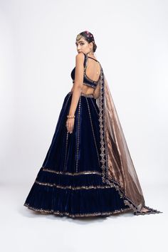 Navy blue without sleeve blouse paired with double tier lehnga and tissue dupatta.From Vvani Vats Mahnoor collection.DELIVERY TIMEPlease allow 8-12 weeks for your outfit to arrive.FABRIC DETAILSVelvet, TissueProfessional cleaning only. Tiered Lehenga, Navy Blue Lehenga, Tissue Dupatta, Vani Vats, Velvet Dupatta, Lehenga Dupatta, Velvet Lehenga, Blue Lehenga, Velvet Blouses