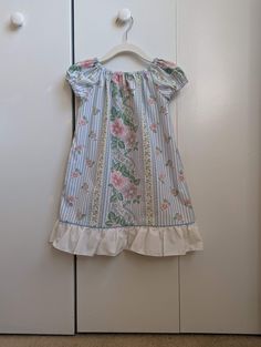 "Your child will feel cool and comfortable all summer long in this loose fitting peasant dress with elastic neckline and sleeve hems. This dress features in-seam pockets, a ruffled hem, and a delicate, pastel blue and pink floral pattern. This listing is for the blue floral dress as shown in the thumbnail. The yellow floral dress on the model is only to show the fit of the dress. This dress is listed as size 2-3, but please be sure to check the measurements, and keep in mind that the neckline an Yellow Floral Dress, Blue Floral Dress, Pink Floral Pattern, Peasant Dress, Floral Blue Dress, Blue And Pink, Pastel Blue, Yellow Floral, Blue Floral