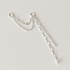 This silver piecing chain charm is a chain for earrings. There are 2 mixed chains. Dangling at the end of one of the chains there is a tiny crystal. The earring chain is solid sterling silver 925. If you have any questions please contact me, thank you :) Chain Charm - solid sterling silver 925 Silver Dangle Earrings With Delicate Chain, Silver Dangle Chain Cartilage Earrings, Minimalist Silver Cartilage Earrings With Chain, Silver Sterling Silver Cartilage Earrings With Adjustable Chain, Helix Chain, Chain Piercing, Cartilage Chain, Piercing Chain, Earring Chain