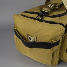 a duffel bag with two zippers on the side and an open pocket in the middle