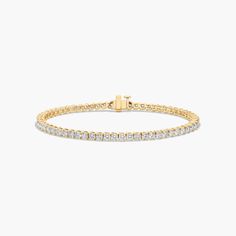 a diamond tennis bracelet in yellow gold