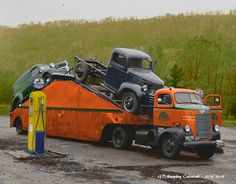 an orange tow truck with two green trucks on it's flatbed and one is towing another car