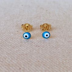 A dainty minimalist 18k Gold Filled evil eye stud earrings featuring aqua colored enamel finish. Metal: 18k Gold Filled Dimension: 2.5mm stud Weight 0.4 grams/ pair Hypoallergenic and waterproof jewelry Handcrafted in Brazil Learn how to care for your jewelry with these easy instructions. Properly handling and caring for your ArtBossa jewelry is essential in maintaining its pristine condition. 1. Keep your gold-filled jewelry away from chemicals and cleaning products. Remove your jewelry when handling them to keep it in good condition. 2. To protect your jewelry, don't apply perfume directly on it. Apply fragrance to your body first and wait a few minutes before putting on jewelry. Alcohol in perfume can damage your precious pieces. 3. Only clean the item with mild soap and water to mainta Yellow Gold Evil Eye Earrings For Gift, Turkish Eye, Waterproof Jewelry, Aqua Color, Birthstone Charms, Earring Sale, Play Dress, Gold Filled Jewelry, Star Earrings