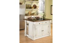 a white kitchen island with an open shelf on the top and two shelves above it