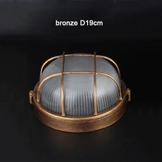 an image of a light that is on top of a black surface with the words bronze d 19cm