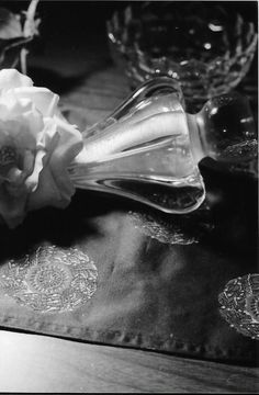 black and white photograph of glass vases with flowers