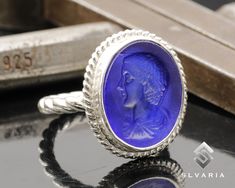 925 Silver Ancient Glass Intaglio Caesar Roman Coin Signet Ring Handmade Turkish Fine Jewelery Unique Dainty Ring Historical Art Design Ring ⭐3 YEAR GUARANTEE FOR ANTI-TARNISH⭐ 💍Item Details💍 SKU CODE: IMM23009B ★ Material: 925 Sterling Silver (Rhodium Plated) ★ Silver Weight: App. 5.10 Grams {6 USA Size] ★ Ring Diameter: 2.3 mm ★ Ring Size: Available in variations  ★ Coin: Caesar ★ Coin Size: 20,30X18,10 mm (With Border) ★ Coin Metarial: Blue Glass  ★ Ring Plate: Available in variations to Ro Ring Plate, Fine Jewelery, Glass Ring, Natural Stone Jewelry, Historical Art, Glass Rings, Dainty Ring, Signet Ring, Ring Handmade