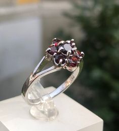 Valentines Day Perfect Gift !Czech garnet  ring 2.84 grams size 8 us 18 ru Raw Red Garnet Flower Ring / Alternative Unique Organic Rustic  Czech Almandine Red Gemstone Natural Garnet  Ring This listing is for one raw Garnet wave ring. Pictured ring is in 925 sterling silver. DETAILS: Stone:  Almandine Garnet A gorgeously lavish vintage red garnet cluster ring made in gilt silver from the 1960s. There are four tiers of wine-red Bohemian garnets set in an undulating oval bezel setting, rising towa Garnet Cluster Promise Ring In Fine Jewelry Style, Garnet Cluster Ring For Promise, Fine Jewelry, Fine Jewelry Garnet Cluster Ring, Garnet Gemstone Cluster Ring In Fine Jewelry Style, Fine Jewelry Garnet Cluster Ring With Gemstones, Garnet Birthstone Cluster Ring, Fine Jewelry Round Cluster Ring With Garnet, Garnet Gemstone Cluster Ring, Formal Round Garnet Cluster Ring