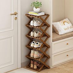 a wooden shoe rack with shoes on it in front of a white door and window