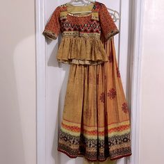 Indian Print Lehenga With Peplum Blouse. Blouse Has High Neck With Coin Detailing. 3/4th Sleeve. New, Never Worn. No Dupatta Traditional Yellow Block Print Sets, Fitted Mustard Sets For Festive Occasions, Yellow Block Print Sets For Diwali, Yellow Bohemian Saree Set, Bohemian Yellow Saree Set, Festive Yellow Block Print Set, Bohemian Yellow Sets With Block Print, Bohemian Yellow Block Print Sets, Yellow Cotton Lehenga With Pallu