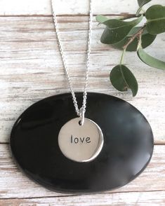 Silver Love Necklace | The Life Divine Our solid sterling silver double sided round disk charm is engraved with the word "Love" This round disk charm measures a 1/2" in diameter. You may purchase the charm on its own or on a shimmering diamond cut ball chain.Select from 3 different Lengths -16”, 18” or 20” Meaningful Round Sterling Silver Jewelry, Meaningful Round Charm Necklaces For Anniversary, Anniversary Hand Stamped Round Disc Charm Necklaces, Meaningful Nickel-free Jewelry, Meaningful Sterling Silver Necklace With Round Pendant, Everyday Round Sterling Silver Charm Necklace, Everyday Sterling Silver Round Charm Necklaces, Meaningful Charm Necklace With Round Pendant For Anniversary, Meaningful Round Pendant Charm Necklace For Anniversary