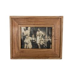 an old photo is hanging in a wooden frame