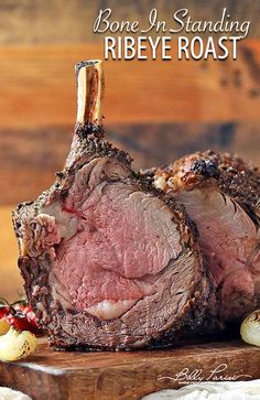 a piece of roast on a wooden cutting board with the title bone in standing ribby roast