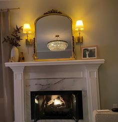 a fire place with a mirror above it