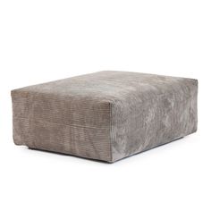 a square footstool made out of grey velvet with an ottoman cover in the middle