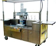 an outdoor food cart is shown with several items on the top and bottom, including bottles