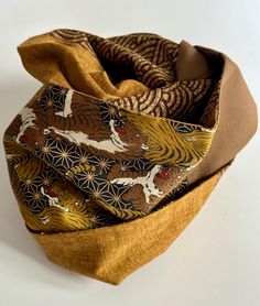 A Snood that combines the elegance of Japanese fabrics and originality, thanks to the chosen fabrics and the shades of ochre and brown. It is made of 3 Japanese cotton fabrics and 1 plain brown cotton to complete the harmony. Like all my snoods, you put the neckband over your head, form an eight with the scarf and put it back over your head a second time. All that remains is to adjust the Snood in front of a mirror so that it is as you like it. The cotton model is so successful that I offer you As You Like It, All That Remains, Japanese Cotton, The Chosen, Japanese Prints, Japanese Fabric, Cotton Fabrics, Scarf Wrap, Halloween Shopping