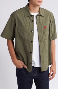 Lightweight, lightly rumpled nylon styled in a mossy green makes a warm-weather favorite of a shirt that looks best when you leave it untucked on sunny days. Front button closure Spread collar Short sleeves Chest patch pockets 100% nylon Machine wash, line dry Imported Green Button-up Shirt With Patch Pockets, Casual Solid Camp Shirt With Spread Collar, Casual Solid Button-up Camp Shirt, Casual Solid Color Button-up Camp Shirt, Classic Green Shirt With Pockets, Casual Solid Shirt With Snap Buttons, Green Work Shirt With Patch Pockets, Casual Khaki Collared Camp Shirt, Casual Khaki Spread Collar Top