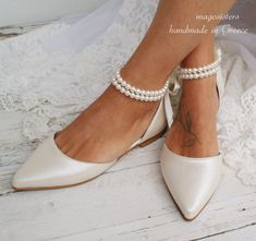 the bride's shoes are adorned with pearls