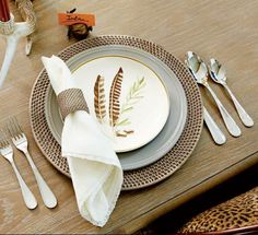 a place setting with silverware and napkins