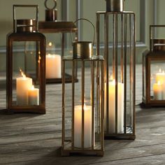 several lit candles sitting on top of a wooden floor