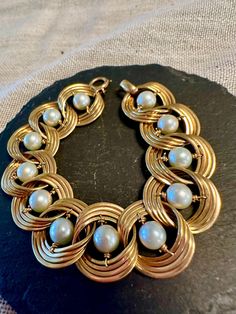 !4k Akoya Pearl Bracelet-Lustrous whit Pearls that revolve inside the circular links-Circa 1950s.  There is a matching necklace listed separately.  Condition is very good for its age, pictures show the quality and details.  Length 6.5", width approx. 3/4", wt.- 27.9 grams.  This is an  easy to wear timeless design. Akoya Pearls, Matching Necklaces, Chain Link Bracelet, Pearl Bracelet, Link Bracelets, Arm Band, Chain Link, Ear Piercings, Timeless Design