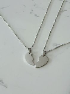 Two half heart necklace set. All materials are stainless steel. Each order comes with 2 necklaces which together will form a whole heart when placed side by side. All necklaces will be 20 inches in length unless requested otherwise.  How to order:  Step 1: Select the colour for your necklace set Heart-shaped Metal Necklaces For Friendship, Heart-shaped Metal Necklace For Friendship, Silver Double Heart Stainless Steel Necklace, Valentine's Day Double Heart Stainless Steel Necklace, Valentine's Day Stainless Steel Double Heart Necklace, Silver Stainless Steel Double Heart Necklace, Valentine's Day Stainless Steel Necklace, Valentine's Day Heart Charm Necklace In Stainless Steel, Heart Pendant Stainless Steel Necklace For Best Friend