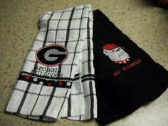 two black and white towels are on the floor next to each other, one has a gatorade embroidered on it