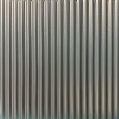 a close up view of the side of a metal wall with vertical lines on it