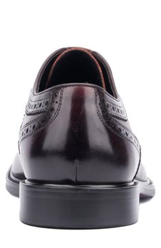 Brogue stitching on the vamp elevates the look of a burnished leather derby finished with a wingtip toe timeless intrigue. Leather upper/leather and textile lining/rubber sole Imported Burgundy Leather Wingtip Shoes, Business Wingtip Oxfords With Leather Lining, Brogue Detailed Snip Toe Dress Shoes For Work, Brogue Detailing Snip Toe Dress Shoes For Work, Classic Burgundy Cap Toe Oxfords, Snip Toe Dress Shoes With Brogue Detailing For Work, Leather Wingtip Oxfords With Brogue Detailing, Business Leather Wingtip Shoes With Perforated Toe, Formal Wingtip Derby Shoes With Leather Footbed