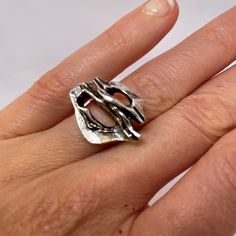 "A custom made designer mid century modernist ring in fine sterling silver.  This unique ring is in lovely condition and is absolute iconic of the era. Dating to the 1970s it could easily grace any coffee table book on fine jewelry design from the period.  In total it weighs 8.1 grams.  The face of the ring itself measures 11/16\" long by 15/16\" wide and rises 5/16\" high off the finger (18mm x 23mm x 8mm).  Currently this amazing hand made custom designed ring is a size 6 3/4. It can be resized to any size required at little cost.  This one of a kind modernist sterling silver ring will be sent in a presentation box." Luxury White Gold Modernist Rings, Modernist Open Band Rings For Formal Occasions, Modern Hallmarked Dome Ring For Promise, Modern Hallmarked Sterling Silver Rings, Modernist Oval Sterling Silver Ring, Modern Silver Rings With Unique Design, Modernist Open Dome Ring As Gift, Modern Hallmarked Open Band Rings, Contemporary Open Ring With Polished Finish