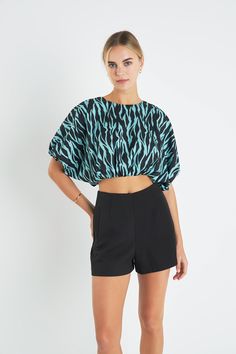 Make a fierce fashion statement in our Tiger Print Voluminous Cropped Top. With its bold and eye-catching tiger print it's the perfect piece to express your wild side. This crop top features a balloon hem for a voluminous look and is fully lined for added comfort. Stand out from the crowd in this fashionable and fun top perfect for any occasion. Tiger print Crop length Balloon hem Fully lined Hand wash cold Do not bleach Do not tumble dry Iron low Shell: 95% Polyester 5% Spandex Lining: 80% Polyester 20% Cotton Exclusive of Elastic TL623T Total length: 17" Bust: 64" Chic Printed Tops For Night Out, Summer Short Sleeve Tops With Tiger Print, Trendy Black Zebra Print Tops, Fitted Black Top With Tiger Print, Fitted Black Tiger Print Top, Graphic Print Cropped Top For Night Out, Trendy Zebra Print Tops For Spring, Trendy Printed Party Tops, Bold Tops For Summer Party