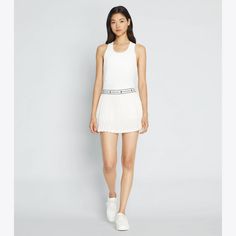 A classic pleated tennis skirt is updated with Double T knit tape along the waistband. The comfortable style features a built-in short with a ball pocket. Designed to support freedom of movement, the on-the-court essential is engineered in lightweight mesh. Sporty Spring Pleated Skirt For Sports, White Athleisure Pleated Skirt Bottoms, White Pleated Skirt Bottoms In Athleisure Style, Sporty Pleated Short Tennis Dress, Sporty Short Pleated Tennis Dress, Athleisure Tennis Skirt With Elastic Waistband, Athleisure Tennis Dress In Short Length, Athleisure Short Tennis Dress, Sporty Pleated Skirt For Summer Sports