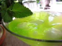 a green drink with ice and mint in it