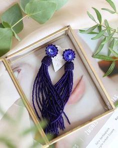 Add a touch of elegance to your outfit with these stunning matte blue beaded tassel earrings. The deep navy blue dangle earrings feature Swarovski crystal studs that add a hint of sparkle to your look. These bohemian-inspired fringe earrings are both trendy and chic, making them the perfect accessory for any occasion. Whether you're dressing up for a special event or adding a stylish touch to your everyday outfit, these seed bead earrings are sure to make a statement. Elevate your style with the Elegant Long Drop Handmade Tassel Earrings, Elegant Handmade Long Drop Tassel Earrings, Blue Fringe Dangle Chandelier Earrings, Blue Tassel Earrings With Round Beads, Handmade Beaded Drop Earrings For Evening, Adjustable Elegant Tassel Earrings For Party, Handmade Drop Earrings For Evening, Blue Fringe Beaded Drop Earrings, Blue Fringed Beaded Drop Earrings