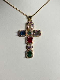 Golden cubic Zirconia cross pendant, necklace Pendant has inlaid colored zirconia stones pendant width 1 inches/2.5 cm pendant height 1 5/8 inches/4.2 cm chain length 17.5-19.5 inches / 44.5-49.5 cm comes with a golden chain as well as a gift bag beautiful colored design gives them such a unique look perfect for First Communion, Baptism, Religious celebrations, birthdays, Easter, Mother's day The colors from your monitor might vary slightly from actual colors Please have a look at the other item Unique Cross Necklace, Cute Cross Necklace, Guerriero Samurai, Baroque Necklace, Streetwear Jewelry, Golden Chain