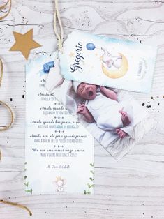 a baby's birth announcement is shown on a wooden table with stars and twinkies