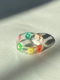 Resin Ring made with high quality resin with cute flower charms inside! Resin Ring Ideas, Flower Resin, Diy Rings, Resin Ring, Cute Flower, Ring Ideas, Flower Charm, Stackable Rings, Jewelry Rings