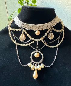 Beautiful Victorian inspired choker necklace with multiple layers of glass and polished pearl beads and silver chains with Mother of Pearls. Its one of a kind piece. I have used a crochet lace as a base  for a romantic touch and victorian inspired style.Perfect for a fashion statement. The height of the necklace is 5.25 inches approximately. The choker size is adjustable. Ready to ship. Comes in a gift box. Vintage Adjustable Pearl Choker, Vintage Pearl Beaded Choker, Handmade Bohemian Pearl Necklace For Party, Handmade Adjustable Pearl Necklace For Party, Adjustable Handmade Pearl Necklace For Party, Handmade Cream Necklace For Party, Handmade Cream Choker Necklace, Victorian Choker, Silver Chains