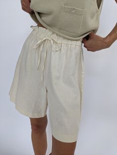 Easy buttercream shorts set in a woven linen material. The shorts have a gathered waistline with a drawstring waist, and long relaxed drape. Tag reads Roo Crossing Long Linen Shorts, Beige Linen Shorts For Beach, Beige Linen Shorts For The Beach, Neutral Shorts For Summer Beach, Neutral Shorts For Beach In Summer, Summer Beach Neutral Shorts, Relaxed Linen Shorts For Day Out, White High-waisted Linen Bermuda Shorts, Neutral Shorts For Summer Vacation